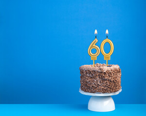 Birthday celebration with candle 60 - Chocolate cake on blue background