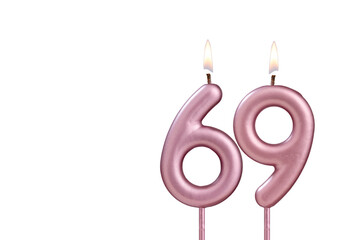 Lit birthday candle - Candle number 69 on white background