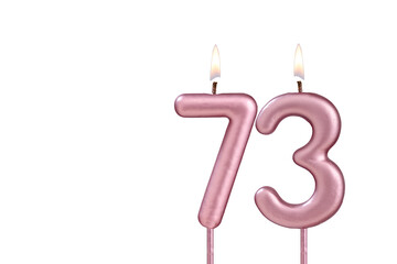 Lit birthday candle - Candle number 73 on white background