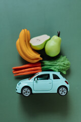 groceries online and delivered to their doorstep. Delivery of vegetables and fruits. blue car with...