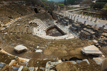 Naklejka premium Aerial view of remains of small Odeon used as bouleuterion and theatre and State Agora columns in Greek settlement of Ephesus after reconstruction..