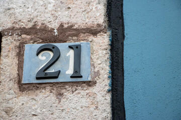 Number twenty one, 21, on stone wall