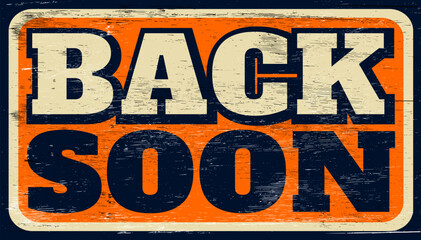 Aged and worn be back soon sign on wood