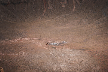 Barren Arizona landscape at Meteor Crater, a geological wonder formed by a meteorite impact. Muted...