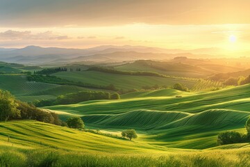 A beautiful landscape of green hills in Tuscany, Italy. The sun is setting and the sky is a warm orange. AIG51A.