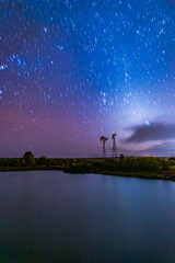 Star trail over a lake with windmills, in Monte Escobedo, Zacatecas 