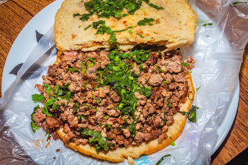 Beef gordita with spicy sauce, vegetables and lemon, Mexican dish, Mexican food