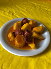 medium-cooked yam with Calabrian sausage sauce on a white porcelain plate