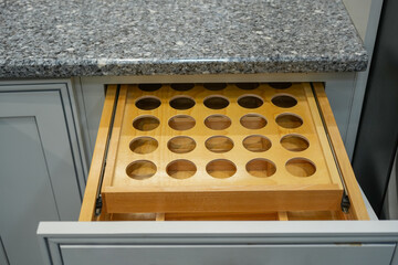kitchen drawer with wooden frame for condiment bottle