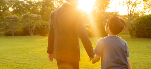 Visionary and eco conscious businessman father guide his son to the bright future with sunset...