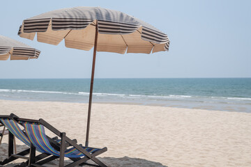 Beach chair and umbrella on the white sand beach