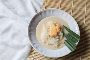 Sticky rice with durian in coconut milk. Asian Thai dessert summer tropical fruit food. Khao Nieow Nam Kati Durian