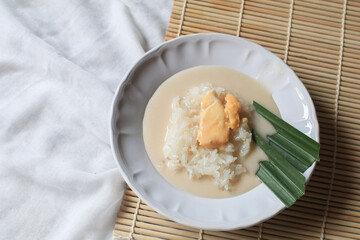 Sticky rice with durian in coconut milk. Asian Thai dessert summer tropical fruit food. Khao Nieow...