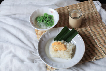 Asian Thai dessert, Sticky rice with durian in coconut milk and Lod Chong on table. 