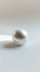 A single, perfectly round pearl floating in a vast expanse of empty white space