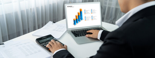 Business intelligence analyst use BI software on laptop to analyze financial data dashboard....