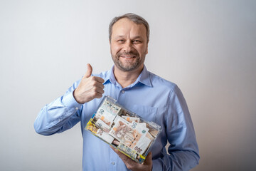 Positive middle aged man showing a thumbs up gesture. OK. transparent donation box for money donation. giving Charity banknotes. financial support, collects money. The act of giving 
