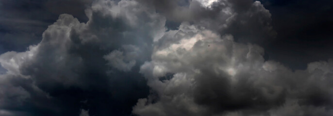 Banner Dramatic dark storm clouds black sky background. Dark thunderstorm clouds rainny season. Panorama Meteorology danger windstorm disasters climate. Dark cloudscape storm cloud with copy space.