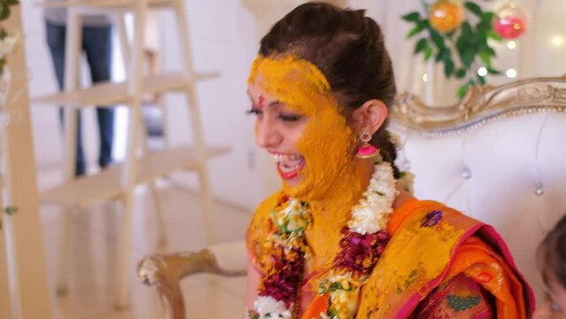 Guests Applying Turmeric Haldi Onto Bride During Indian Pithi Ceremony - Close Up