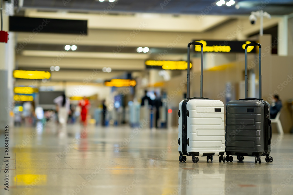 Wall mural travel, two suitcases in an empty airport hall, traveler cases in the departure airport terminal wai