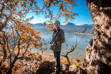 Man looking at the camera with a landscape in the background, lake and mountains of Bravo Valley,...