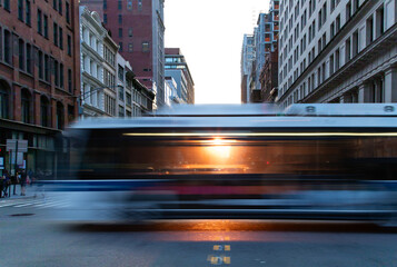 Sunlight shining through a city bus as it's driving down the street on 5th Avenue in New York City...