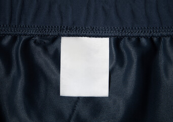 Close up of blank white color clothing label on cloths