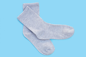 Grey socks on blue background.
