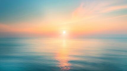 Obraz premium Dreamy ocean sunrise with the sun gently peering above the horizon, casting soft reflections on tranquil waters under a pastel sky.