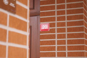 house number. Decorative lettering on a brick wall.