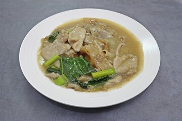 Wide Rice Noodles with Pork in Gravy Sauce, Thai dishes close up high angle view