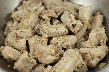 Pile of marinated pork rib with garlic and special sauce. Famous raw food concept. Preparation food in kitchen.
