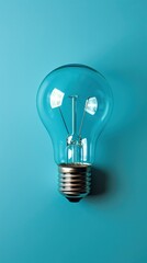 Glowing light bulb, on cyan background. Great idea concept. Copy space for text