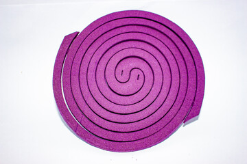 violet spiral Mosquito Repellent coil isolated on white background, A mosquito coil is a mosquito-repelling incense. Light mosquito coil for protect from dengue or malaria.