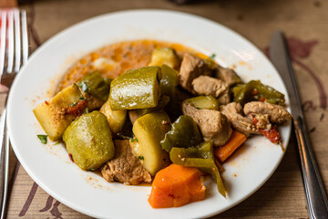 Beef and Vegetable Stew on served table in a café or restaurant, copy space. Traditional meat dish