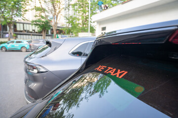 Electric taxi car at charging station in Hanoi, Vietnam