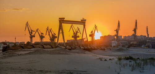 Industrial landscape:sunset over industrial areas,pipelines running through sandy desert