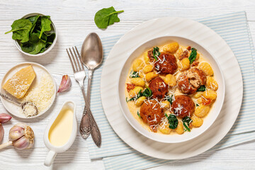 tuscan chicken meatballs with gnocchi in a bowl