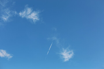 The sky has airplanes on a clear day.