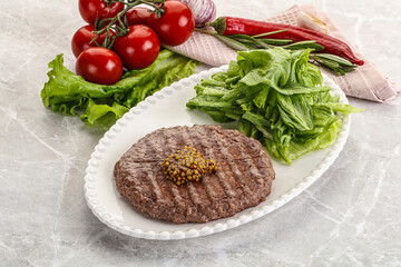 Frilled beef burger cutlet with iceberg