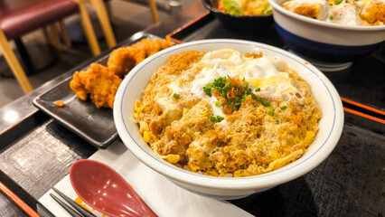 Katsudon japanese food, bowl of rice topped with fried pork cutlet
