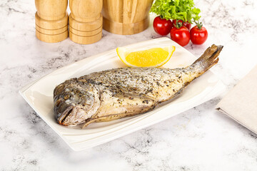 Baked Dorado fish served lemon