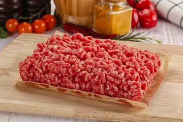 Raw minced beef meat over board