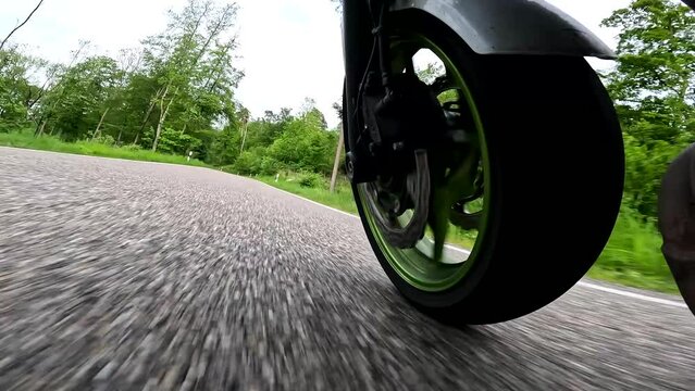 solo ride of amateur biker on motorcycle. Motorcyclist racing his motorcycle on country road. Close-up view.