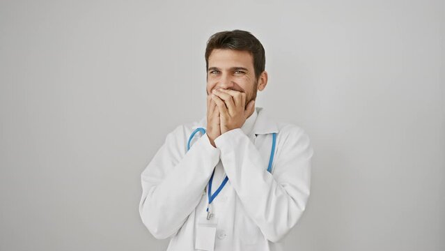Cheerful hispanic guy wearing stethoscope covers mouth with hand in embarrassing laugh over juicy gossip, isolated on white