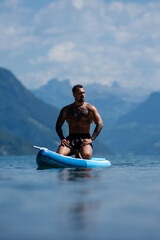 Muscular man relax in water at the lake. Attractive male sexy model in water. Handsome boy rest in Alps lake water. Sexy man naked torso in water. Man freedom lifestyle. Strong muscles guy.