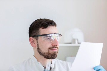 Scientist male with lab glasses working in a laboratory