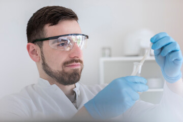 Scientist male with lab glasses working in a laboratory