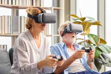 Senior caucasian couple playing video game using virtual reality glasses and joystick
