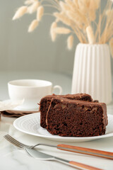 Fresh homemade chocolate sponge cake on wooden board